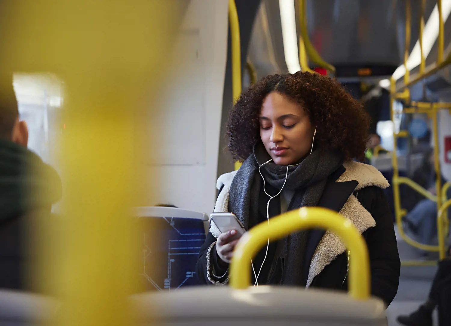 Person på buss tittar i sin mobiltelefon